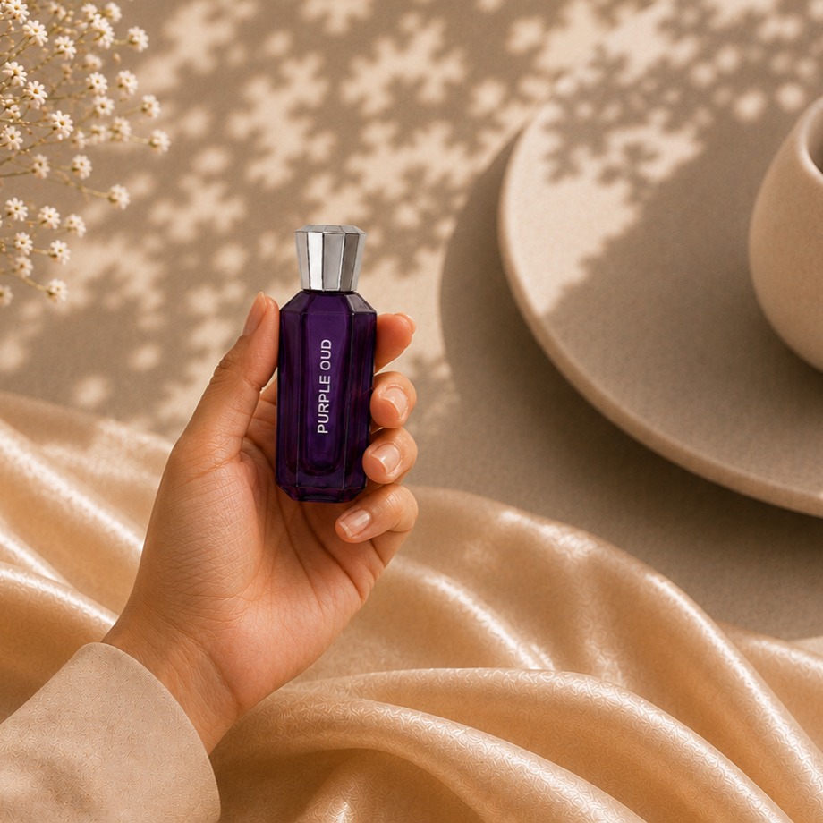 Jazim Perfumes Purple Oud roll-on attar bottle with soft luxury fabric and floral background in warm aesthetic lighting